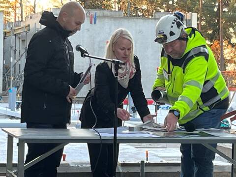 Rakennuttajainsinööri Inga Elsilä ja työmaavalvoja Olli Lehtinen täyttivät kiinteistöjohtaja Kalle Luoman valvonnassa peruskiveen muurattavaa lieriötä.